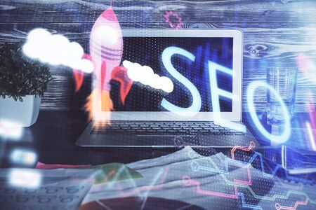 Multi exposure of table with computer and seo drawing hologram. Search optimization concept.の写真素材