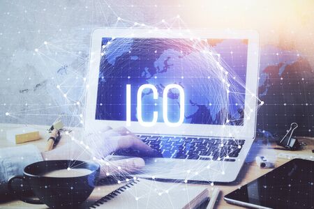 Crypto currency theme hologram with businessman working on computer on background. Concept of blockchain. Double exposure.の写真素材