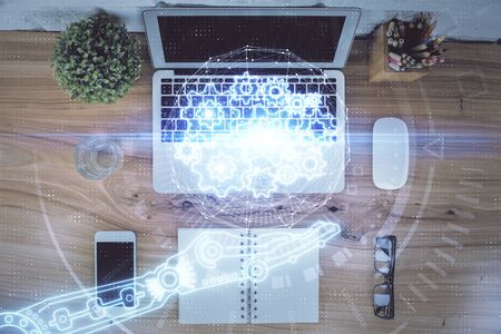 Double exposure of data theme drawing hologram over topview work table background with computer....