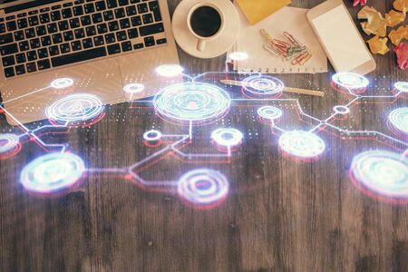 Social network hologram drawings over computer on the desktop background. Top view. Double exposure.の写真素材