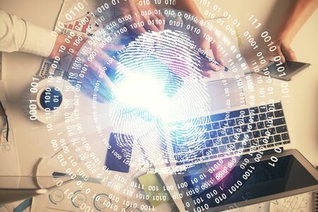 Double exposure of man and woman working together and fingerprint drawing. Computer background. Top View. Security concept.の写真素材