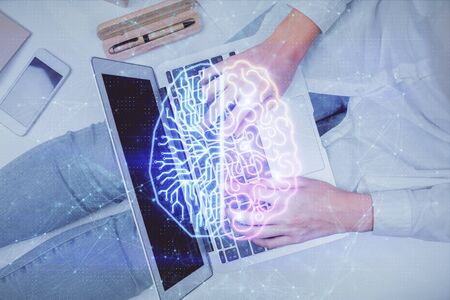 Double exposure of woman working on computer andhuman brain hologram drawing. Top View. Ai concept.の写真素材