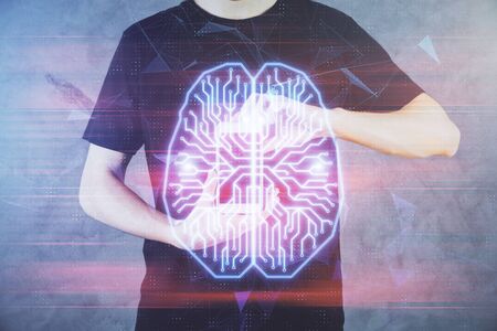 Double exposure of mans hand holding and using a digital device and brain hologram drawing. Data concept.の写真素材