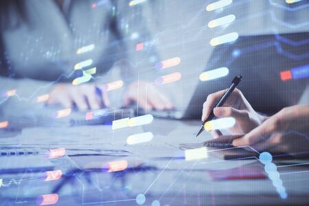 Double exposure of woman hands working on computer and data theme hologram drawing. Tech concept.の写真素材