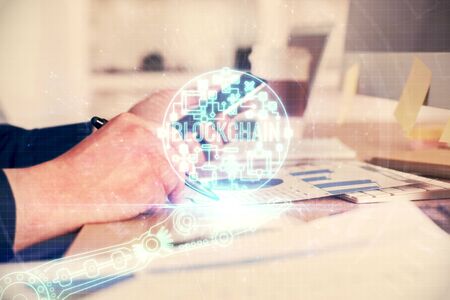 Double exposure of mans hands holding and using a phone and crypto currency blockchain theme drawing.の写真素材