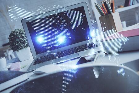 Computer on desktop with social network hologram. Multi exposure. Concept of international people connections.の写真素材