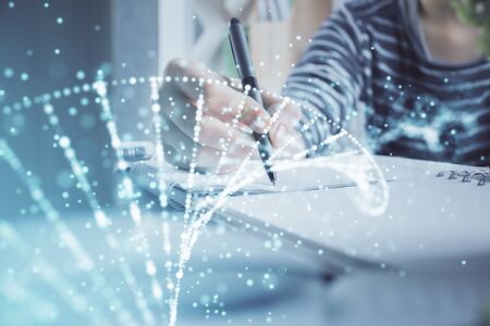 DNA theme hologram over womans hands writing background. Concept of education. Double exposureの写真素材