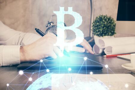 Double exposure of mans hands holding and using a phone and crypto currency blockchain theme drawing.の写真素材