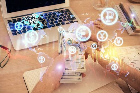 Multi exposure of financial graph drawing hologram and USA dollars bills and man hands. Analysis...