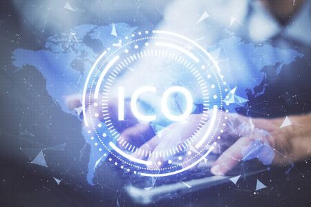 Crypto currency theme hologram with businessman working on computer on background. Concept of blockchain. Double exposure.の写真素材