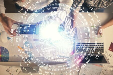 Double exposure of man and woman working together and fingerprint drawing. Computer background. Top...