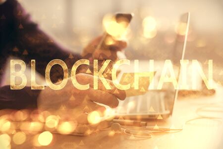 Double exposure of mans hands holding and using a phone and crypto currency blockchain theme drawing.の写真素材