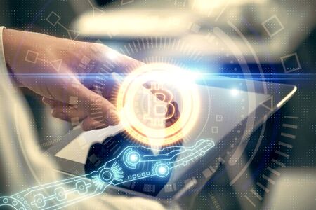 Double exposure of mans hands holding and using a phone and crypto currency blockchain theme...