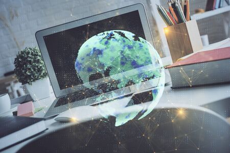 Computer on desktop with social network hologram. Multi exposure. Concept of international people connections.の写真素材