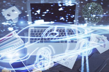Desktop computer background in office with automobile hologram drawing. Multi exposure. Tech concept.の写真素材
