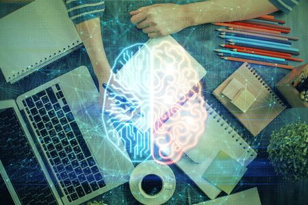 Multi exposure of writing hand with brain hologram.の写真素材