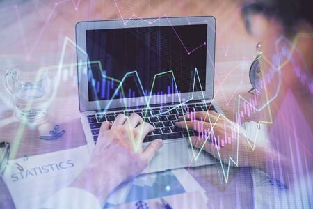 Multi exposure of market chart with man working on computer on background. Concept of financial analysis.の写真素材