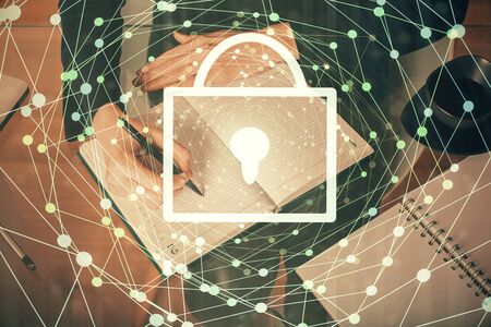 Multi exposure of womans hands making notes with lock icon.の写真素材