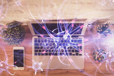 Neuron hologram drawings over computer on the desktop background. Top view. Multi exposure. Concept of education.の写真素材