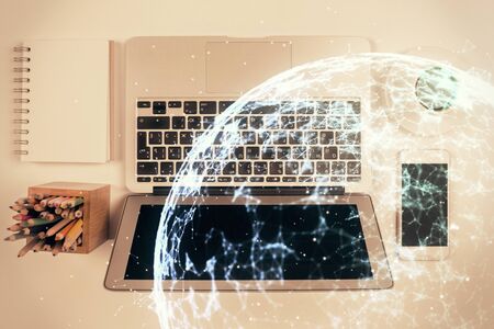 Social network hologram drawings over computer on the desktop background. Top view. Double exposure.の写真素材