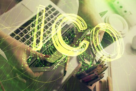 Double exposure of woman hands typing on computer and crypto market theme hologram drawing....