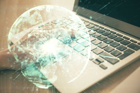 Double exposure of woman hands typing on computer and business theme hologram drawing. Success...