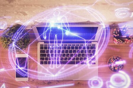 Education hologram drawings over computer on the desktop background. Top view. Multi exposure.の写真素材