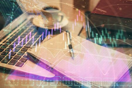 Double exposure of forex chart drawing and desktop with coffee and items on table background. Concept of financial market tradingの写真素材