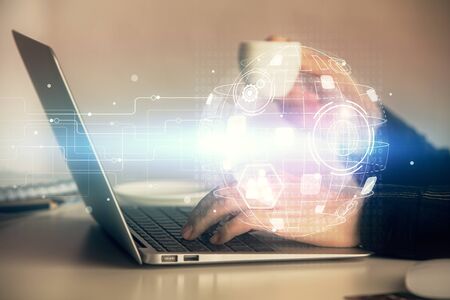 Double exposure of woman hands typing on computer and social network theme hologram drawing. People...