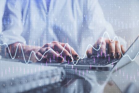 Double exposure of woman hands typing on computer and forex chart hologram drawing. Stock market...
