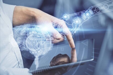 Double exposure of mans hand holding and using a digital device and brain hologram drawing. Data...