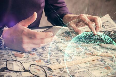 Double exposure of mans hands holding and using a phone and social network theme drawing.の写真素材