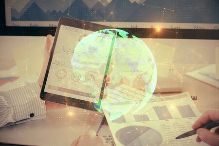 Double exposure of mans hands holding and using a phone and social network theme drawing.の写真素材