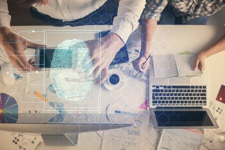 Double exposure of man and woman working together and fingerprint drawing. Computer background. Top...