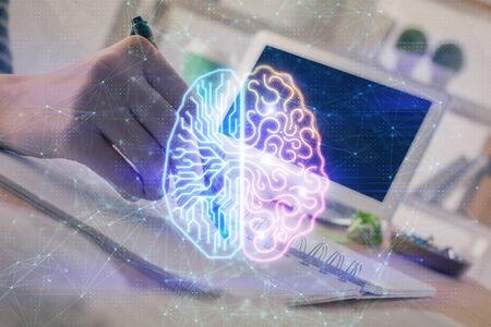 Multi exposure of writing hand on background with brain hologram. Concept of self learning.の写真素材
