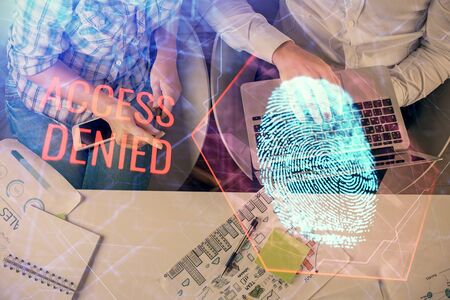 Double exposure of man and woman working together and fingerprint drawing. Computer background. Top View. Security concept.の写真素材