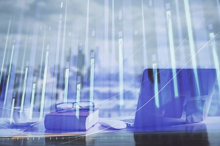 Double exposure of financial chart drawings and desk with open notebook background. Concept of forex marketの写真素材
