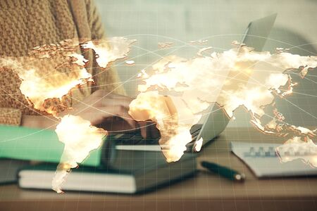 Double exposure of woman hands typing on computer and business theme hologram drawing. Success concept.の写真素材