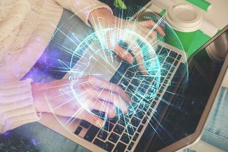Double exposure of woman hands typing on computer and business theme hologram drawing. Success...