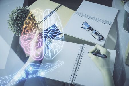 Double exposure of woman on-line shopping holding a credit card and brain hologram drawing. Data...