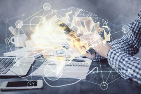 Double exposure of mans hand holding and using a digital device and brain hologram drawing. Data concept.の写真素材