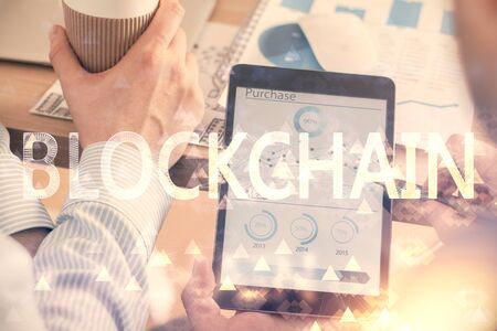 Double exposure of mans hands holding and using a phone and crypto currency blockchain theme drawing.の写真素材