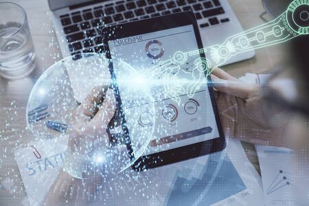 Double exposure of mans hand holding and using a digital device and data theme hologram drawing. Technology concept.の写真素材