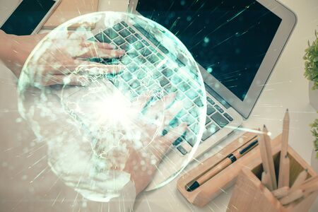 Double exposure of woman hands typing on computer and business theme hologram drawing. Success concept.の写真素材