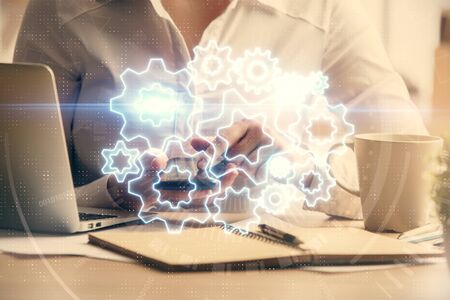 Double exposure of business theme sketch hologram and woman holding and using a mobile device.の写真素材