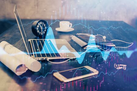 Financial chart drawing and table with computer on background. Double exposure. Concept of international markets.の写真素材