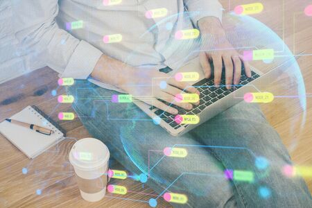 Multi exposure of technology hologram with man working on computer background. Concept of big data.