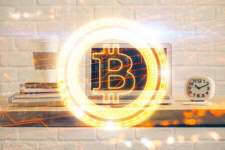 Multi exposure of blockchain theme hologram and table with computer background. Concept of bitcoin crypto currency.の写真素材
