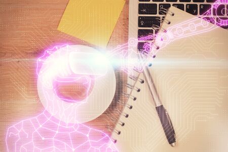 AR hologram drawings over computer on the desktop background. Top view. Multi exposure. Concept of augmented reality.の写真素材