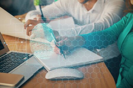 Double exposure of fingerprint drawing over people taking notes background. Concept of securityの写真素材
